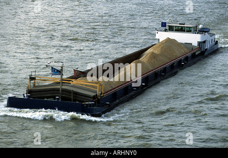 Aggregates for the building trade being transported by bardge on the river Rhine in Cologne, North Rhine-Westphalia, Germany. Stock Photo