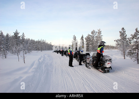 Group With Snowmobiles Enjoying the View Near Levi in Northern Finland Lapland Arctic Circle Stock Photo
