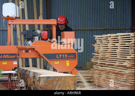 A log being milled using a Wood Mizer LT15 sawmill Stock Photo