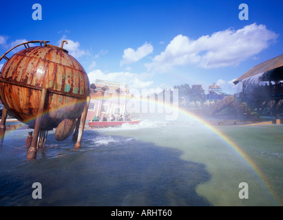 Rainbow caused by the spray from the Tidal Wave ride at Thorpe park. England, UK Stock Photo