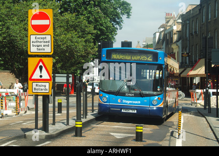 Cambridge university town Citi single decker bus entering restricted traffic zone entry controlled by automated rising bollards England UK Stock Photo