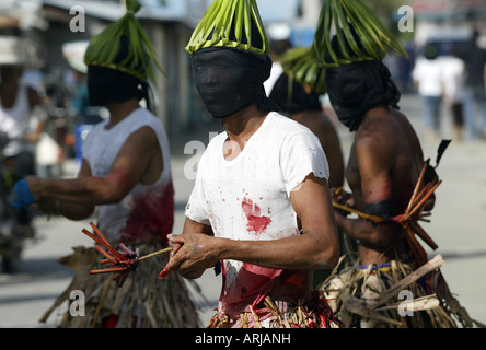 Penitent Filipinos flagellate themselves with bamboo whips on Good Friday in Mansalay, Oriental Mindoro, Philippines. Stock Photo