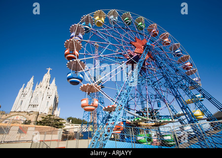 Sacred heart and ferris wheel in tibidabo amusement park Stock Photo