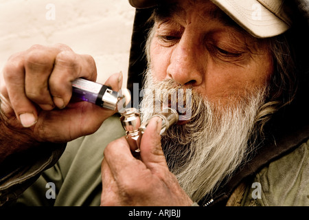 Man smoking marijuana with a pipe Stock Photo