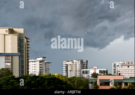 Dark clouds over city skyline Stock Photo