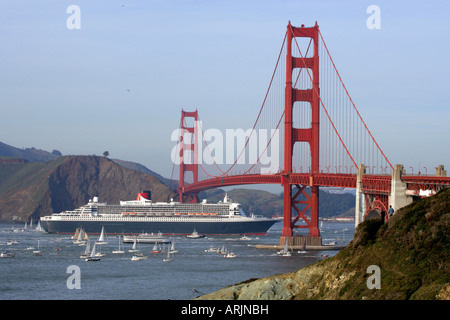 Cruise ship passing under a bridge, RMS Queen Mary 2, Golden Gate Bridge, San Francisco, California, USA Stock Photo