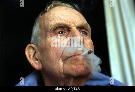 Man smoking a hand rolled cigarette Stock Photo