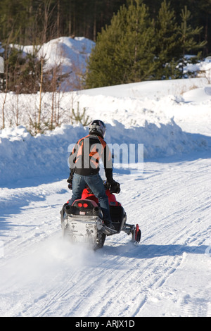 Young man driving snowmobile at Winter , Finland Stock Photo