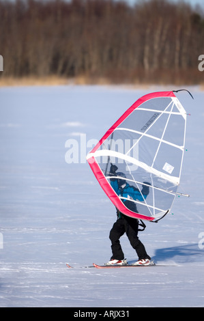 Man skiing on sea ice at Wintertime using a kitewing , Finland Stock Photo