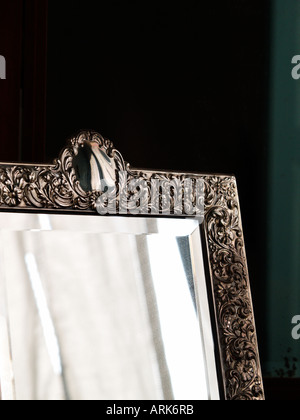 corner of mirror with ornate silver frame Stock Photo