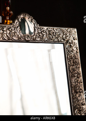 corner of mirror with ornate silver frame Stock Photo