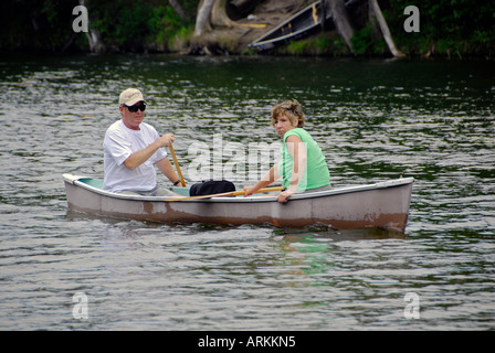 Canoeing on the Au Sable River at the Rifle River Recreational Area near Mio Michigan MI husband wife teamwork couple Stock Photo