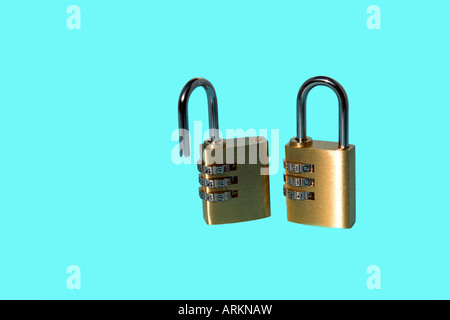 Two combination padlocks on blue background. Stock Photo