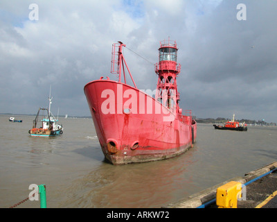 Tugboats manoevring a Trinity House light ship in the harbour at Harwich, Essex, UK Stock Photo