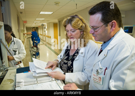 Doctor and Nurse Check Patient Records Stock Photo