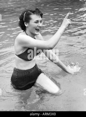 British woman in bikini playing in water Kulri Mussorie Uttar Pradesh India 1940s old vintage picture Stock Photo