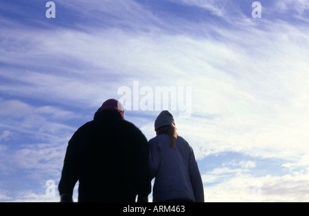 Mother and child holding hands wearing winter clothes Stock Photo