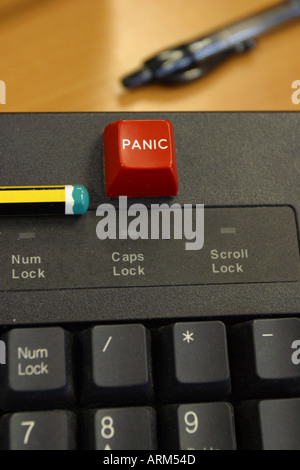 Panic button on computer keyboard with office pen and pencil on desktop Stock Photo