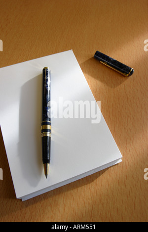 Notepad paper with pen on desk desktop Stock Photo