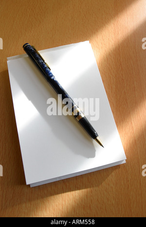 Notepad paper with pen on desktop in business office desk Stock Photo