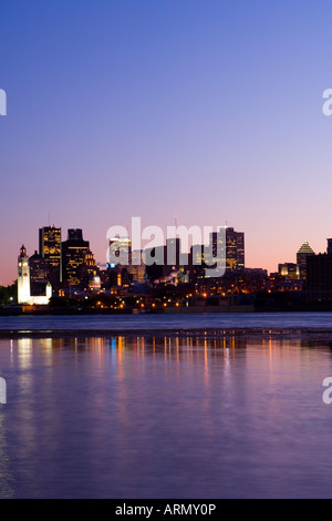 Evening view of skyline with old Montreal in foreground, across St. Lawrence River from Ile Notre-Dame, Montreal, Quebec, Canada Stock Photo