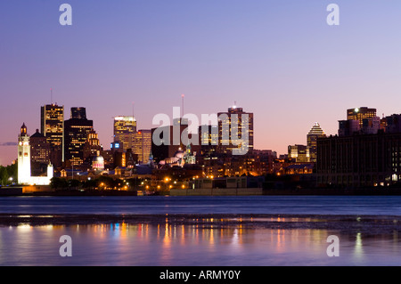 Evening view of skyline with old Montreal in foreground, across St. Lawrence River from Ile Notre-Dame, Montreal, Quebec, Canada Stock Photo