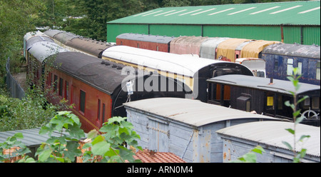 A collection of old vintage railway carriages and wagons waiting to be restored Wales. UK Stock Photo