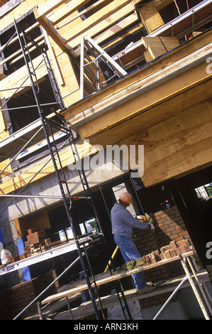 Construction worker. Bricklayer applies mortar while constructing brick wall, British Columbia, Canada. Stock Photo