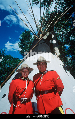 Native Canadians, members of Royal Canadian Mounted Police, in front of TeePee, British Columbia, Canada. Stock Photo