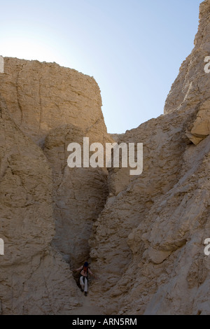 Women is climbing in the limestone Valley of the Kings West Bank Luxor Nile Valley Egypt Stock Photo