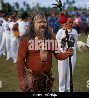 Tau’a warrior from Easter Island with Moai statuette tahonga necklace and feathered ua staff at the Pacific Arts Festival Stock Photo