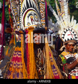Close up of male & female tribes people with tall elaborate feathered headdresses from Papua New Guinea Stock Photo