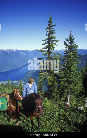 horseback trail riders, Slocan Lake, Kootenays near New Denver, Idaho Peak, British Columbia, Canada. Stock Photo