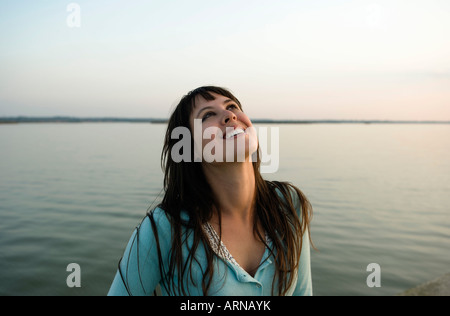 Girl laughing looking skywards Stock Photo