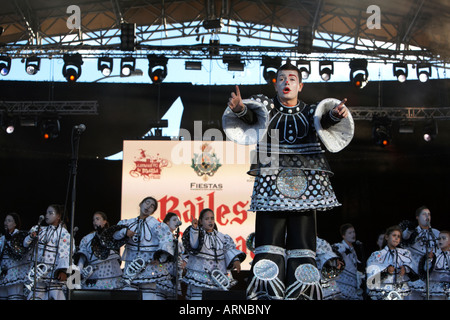 teenage boy in front of local children in costume perform on the big stage at the carnaval in santa cruz de tenerife canary isla Stock Photo