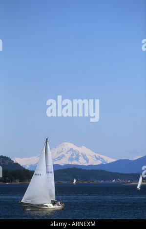 Sidney waterfront, sloop and Mt Baker, Vancouver Island, British Columbia, Canada. Stock Photo