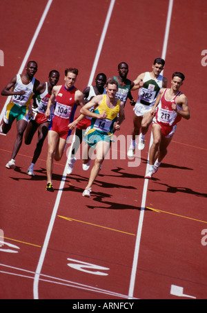 Middle distance runners on rust track in group, British Columbia, Canada. Stock Photo