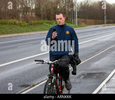 cyclist on phone Stock Photo