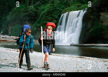 West Coast Trail - hikers at Tsusiat Falls, Vancouver Island, British Columbia, Canada. Stock Photo