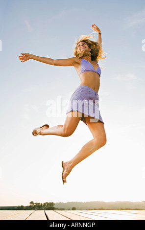 Young woman jumping in the air Stock Photo