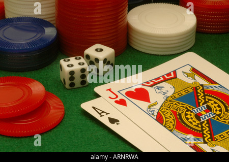 Cards dice and chips on a green felt gambling table. Stock Photo