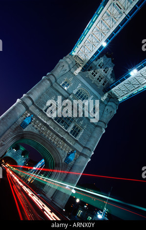 United Kingdom, London,  Tower Bridge at night with streaked lights from traffic.