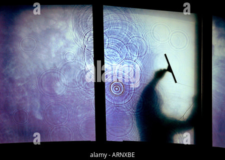 Window cleaner at work in the new education centre at the Eden Project in Cornwall UK Stock Photo