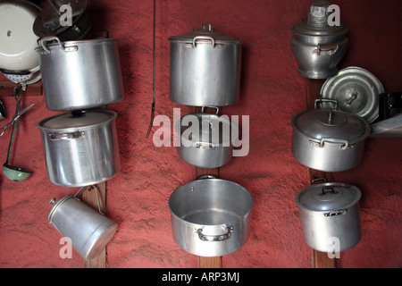 Pans hanged on a wall at an old kitchen Stock Photo