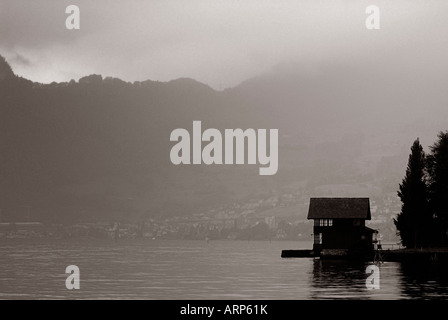 view of a hut on a lake in mist monochrome Stock Photo