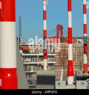 Abstract looking red white striped barriers in vertical position on the Erasmus bridge in Rotterdam, The Netherlands. Stock Photo