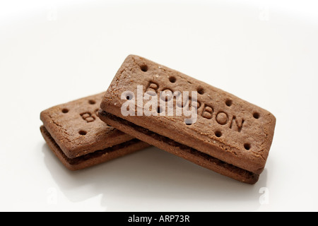 Two Bourbon biscuits arranged on a white plate Stock Photo