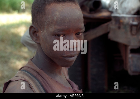 !2 year old Sudanese child Soldier in Southern Sudan, Africa wearing camouflage paint on face Stock Photo