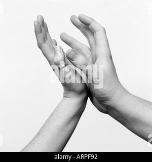 hands in the air one off a girl and a mans Stock Photo