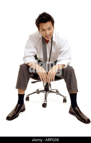 Businessman Sitting in Chair with Loose Tie Stock Photo